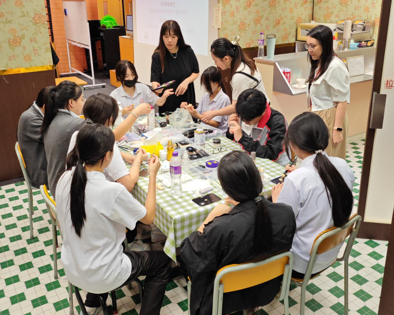 Professional instructor guiding students in makeup techniques